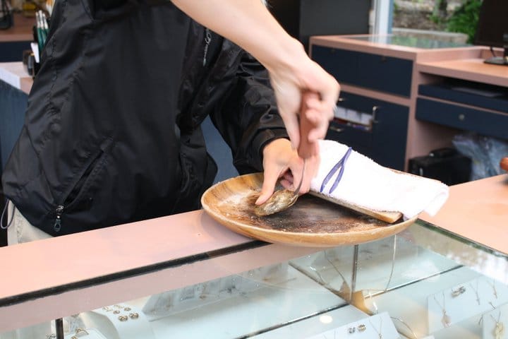 Opening the oyster with a pearl inside.