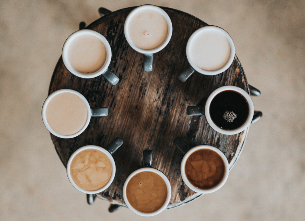 Coffee cups in a circle in different colours. Representing every single person. 