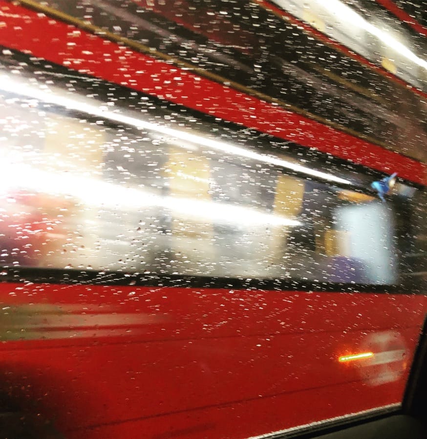 London Bus passing the taxi